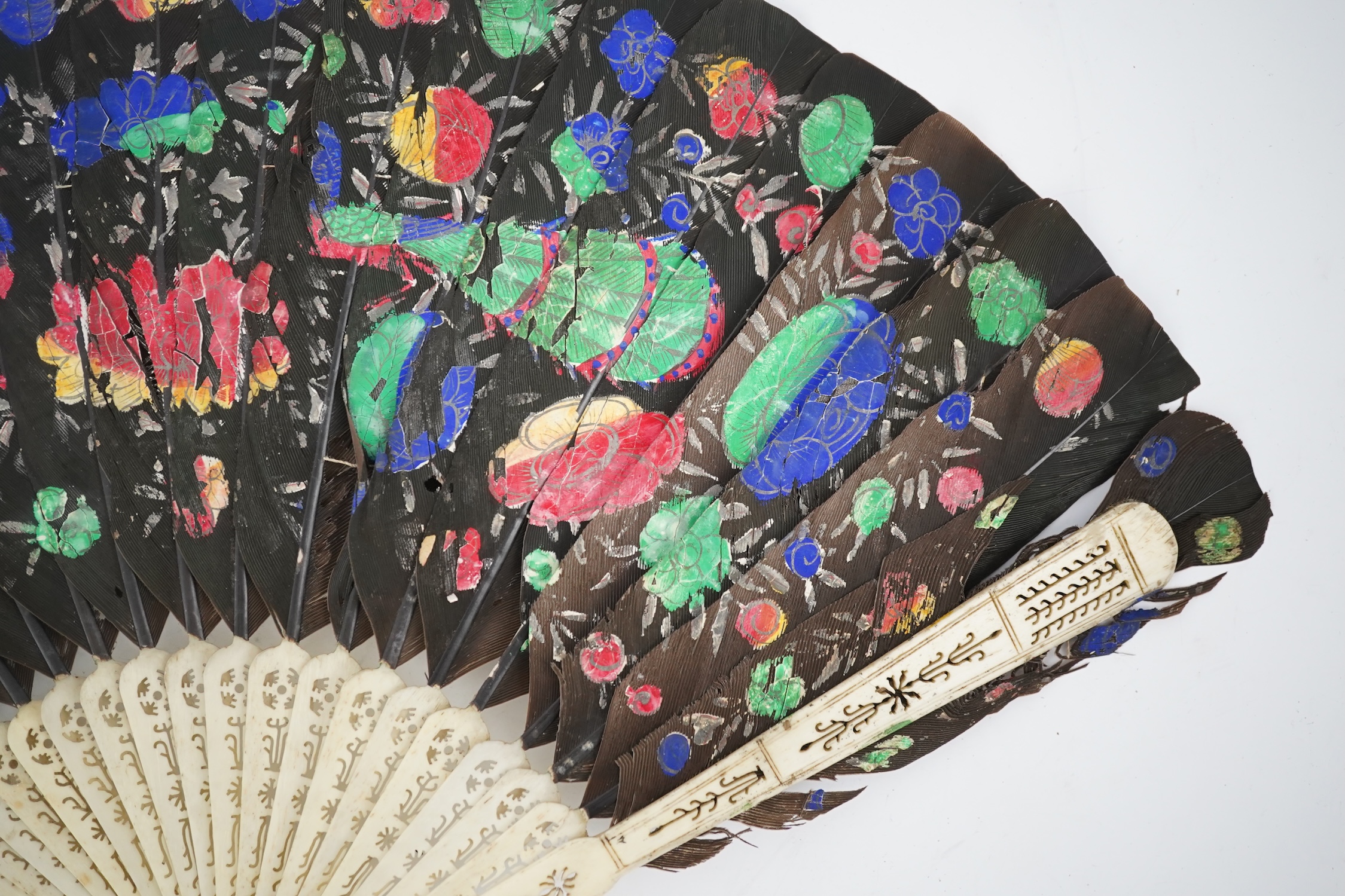 Three 19th century Chinese feather fans: One a carved bone brise black feather fan together with two similar carved sandalwood feather fans, two fans have hand painted decoration on the feathers both sides, the pink feat